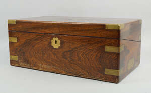
	
		A Victorian rosewood and brass banded writing slope, mid 19th century, opening to a...