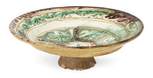 
	
		An scraffiato footed pottery dish, probably Al-Mina, 12th century, of shallow form on a...