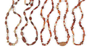 
	
		A group of five ancient and modern amber and glass bead necklaces, comprising round,...