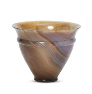 A carved agate cup with flared rim, in the Roman style, 20th century, conical in form, with thin walls, on a flat base with a profiled foot offset from the bod