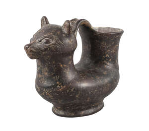 
	
		After the antique, a brown glazed askos modelled as a cat, 29cm long 

	

