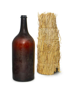 
	
		A French brown glass Methuselah Champagne bottle, late 19th century, with a straw...