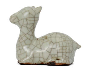 
	
		A Chinese porcelain Guan-type scroll weight, 18th century, modelled as a recumbent deer...