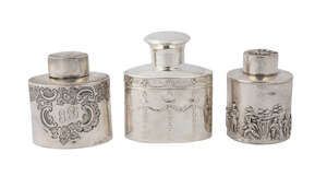 An Edward VII silver tea caddy, Birmingham c.1905, Levi & Salaman, of oval form, with repousse garlands, 9.5cm high x 8.2cm wide, together with a circular silv