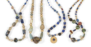
	
		A group of four ancient and modern glass bead necklaces comprised of a necklace of...
