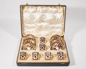 A cased set of six Royal Crown Derby ‘Imari’ pattern 2451 coffee cans and saucers, dated 1917, red printed marks and date cipher, the fitted and silk lined