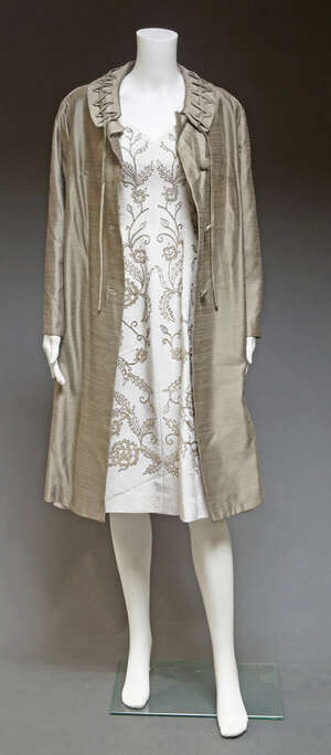 
	
		A sleeveless cocktail dress by Jean Allen,  embellished with silver metal thread, size...