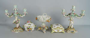 A pair of German porcelain three light candle sticks, late 19th/early 20th century, decorated with a boy and girl  with grapes and flowers in their hands, on p