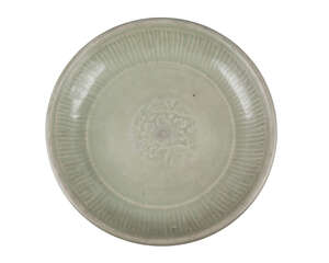 A Chinese grey stoneware Longquan celadon glazed bowl, Ming dynasty, 15th century, moulded with vertical fluting to rim around a central lotus flower, unglazed