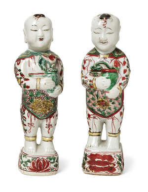 A pair of Chinese porcelain wucai standing figures of smiling boys, hehe, Shunzhi-period, each...