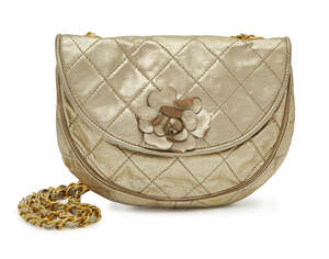
	
		Chanel: a gold quilted leather half moon shoulder bag, with appliqué camellia flower, 