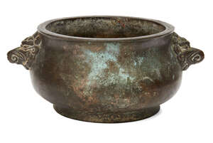 
	
		A Chinese bronze bombe censer, 19th century, cast with mythical beast handles, the base...