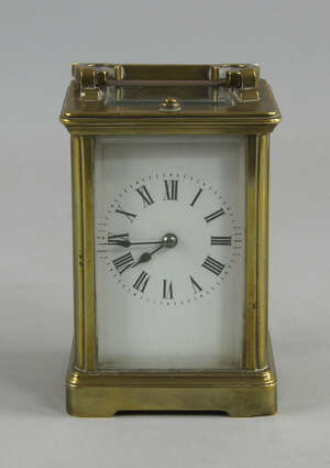 
	
		A French brass carriage clock, the white enamel dial with Roman numeral chapter ring,...