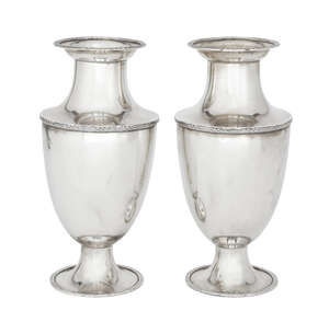 A pair of silver vases, Birmingham, c.1911, D. & B. Co Ltd., of baluster form, each raised on a circular foot, the lip, body and foot of both decorated with a 