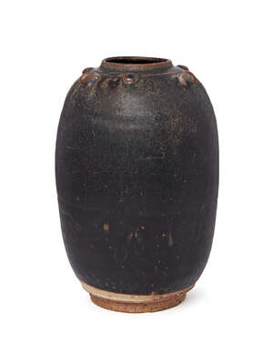 A Chinese stoneware black glazed jar, Song dynasty, of ovoid form, with studded decoration to shoulders, 23cm high