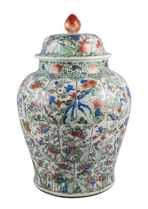 A large Chinese porcelain jar and cover, Kangxi, painted in famille verte enamels with three rows of petal shaped panels enclosing birds amongst floral sprays,