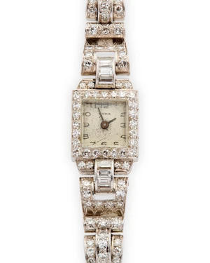 Cyma. A platinum diamond set cocktail bracelet watch Case number 463387, Movement number 140355, Circa 1950The bezel set with single-cut diamonds, with engrav