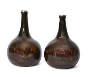 
	
		A pair of Dutch dark green glass bottles, late 17th/early 18th century, of onion form...