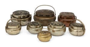 
	
		Eight Chinese metal handwarmers, 19th century - early 20th century, each with pierced...