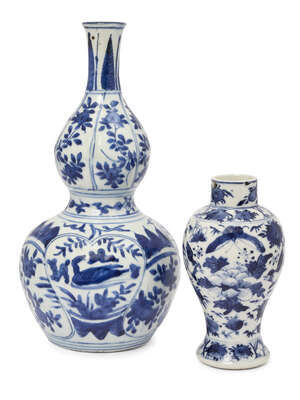 A Chinese export blue and white porcelain double gourd vase, Wanli, the upper tier decorated with vignettes of branches with peaches, the bulbous body with sha