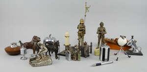 
	
		A spelter model of a seated elephant, 20th century, with a lighter to the interior, 13cm...