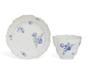A Meissen dry blue glazed cup and saucer, 18th century, with shaped rim to cup and saucer,...