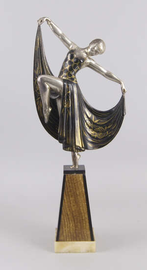 
	
		An Art Deco cold-painted figure of a dancing lady, with gilt decorated dress, standing on...