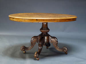 
	
		A Victorian figured walnut tilt top loo table, the oval quarter veneered top on baluster...