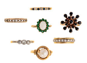 
	
		A group of seven gem-set rings, including a three stone diamond ring set with...