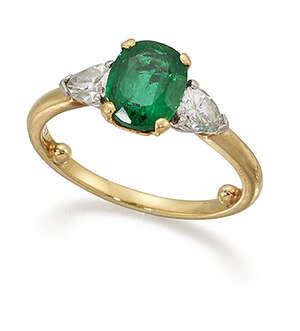 
	
		An emerald and diamond three stone ring by Cartier, the oval emerald between pear-cut...
