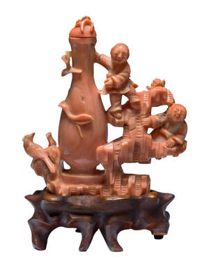 
	
		A Chinese coral snuff bottle, mid-19th century, carved as two boys beside a vase, on...