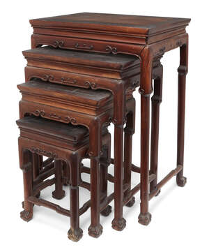 
	
		A nest of four Chinese hardwood occasional tables, early 20th century, each with carved...