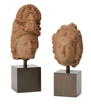 
	
		 Two red clay Bodhisattva heads, Gandhara, 2nd-4th century, each with rounded face with a...