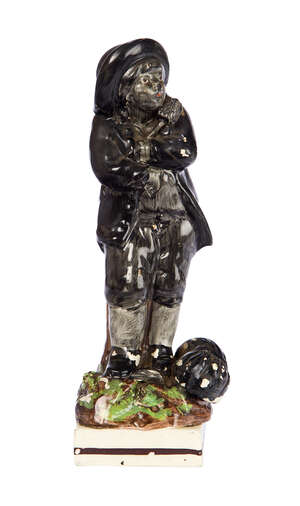 
	
		A Staffordshire pearlware figure of a chimney sweep, early 19th century, with a sack of...