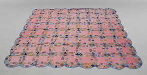 
	
		An American Amish 'Wedding Ring' pattern patchwork quilt, c.1920s, in various patterned...