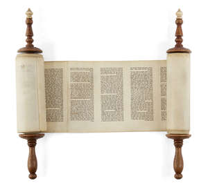 
	
		A miniature Sefer Torah mounted on ivory capped wooden rollers, probably 18th century,...