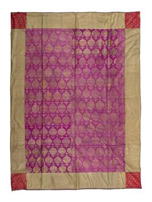 A Mughal gilt metal embroidered silk panel, India, 18th century, of rectangular form, the central panel with repeating design of large floriated medallions enc