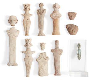 
	
		Two Syrian terracotta Astarte figures, with peg-shaped legs, incised girdle and applied...