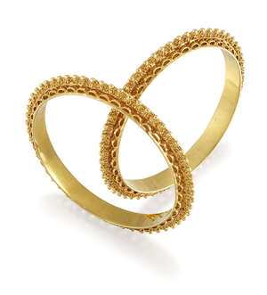Two bangles, of matching hoop design with raised bead and openwork decoration, internal diam. 5.5cm (2)