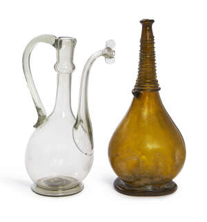 
	
		A clear glass ewer, Iran, 19th century, with long looping handle and spout to a globular...