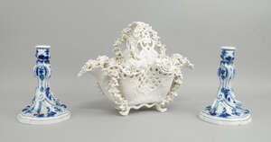 
	
		A pair of Meissen rococo candlesticks, late 19th/early 20th century, decorated with blue...