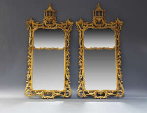 
	
		A pair of giltwood Chinoiserie style wall mirrors, in the style of Thomas Chippendale,...