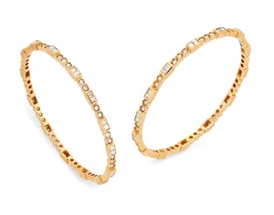 A pair of diamond set bangles, designed as pairs of channel-set carr&eacute;-cut diamonds, alternating...