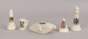 A Goss crested china model of a World War I tank, printed with the crest of Bexhill-on-Sea, together with two crested china models of light houses, a Goss chin