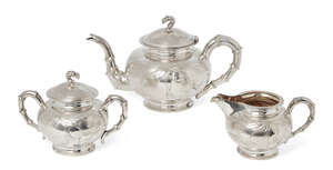 
	
		A Chinese silver three piece tea set, Tuck Chang & Co., repousse decorated with bamboo...