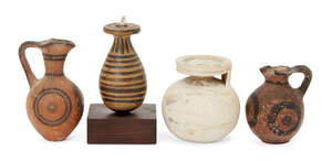 Four pottery vessels, including a Corinthian spherical aryballos with worn lotus decoration, 6.8cm; an Etrusco-Corinthian alabastron with encircling band decor