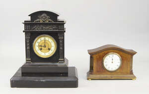 
	
		A French black slate mantel clock, late 19th century, applied to the architectural form...