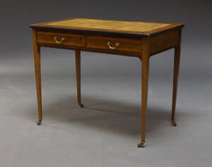 
	
		An Edwardian mahogany and satinwood cross banded writing table, the rectangular top inset...