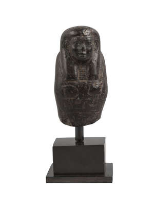 
	
		An Egyptian fragmentary steatite ushabti, mounted on a plinth, 9cm. high
		 
		