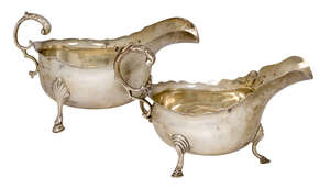 
	
		Two silver sauce boats, the larger example Birmingham, c.1911, Williams Ltd., raised on...